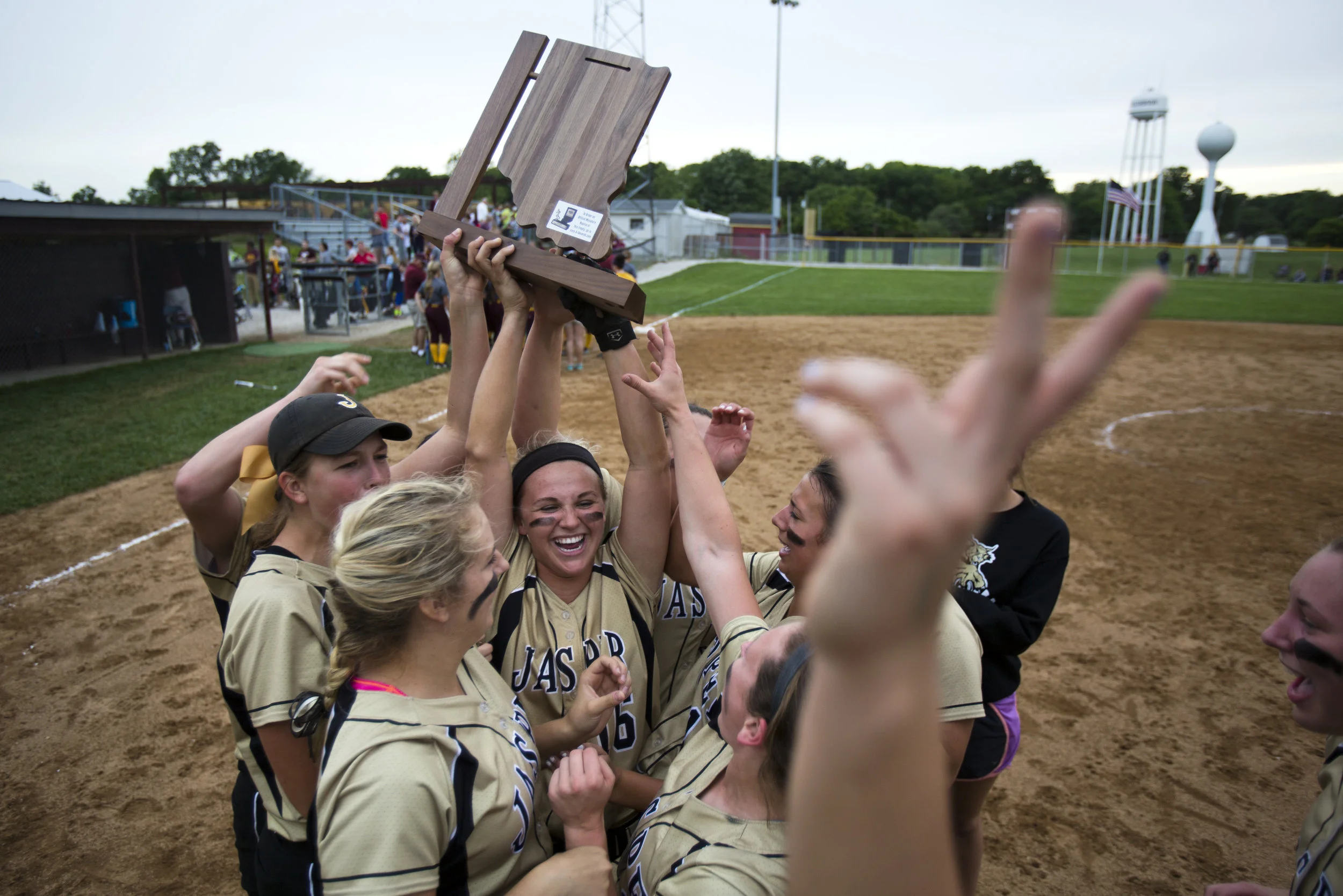  26 May 2016, Petersburg, In -- Jasper's Nicolette Eckert hoists the Class 3A sectional championship trophy as the Wildcats celebrated their 3-0 win over Pike Central in Petersburg.&nbsp;  (Copyright The Herald)&nbsp; 