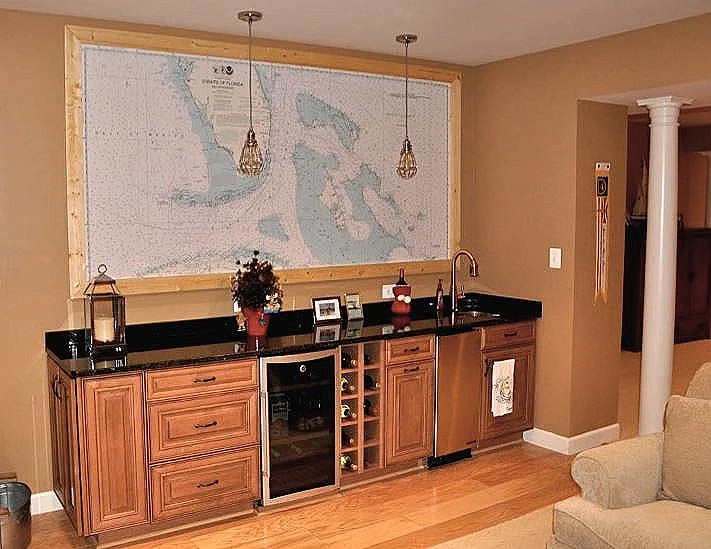 Sailing waters make great conversation around this nicely designed family room bar. They placed the mural and framed it on the wall.