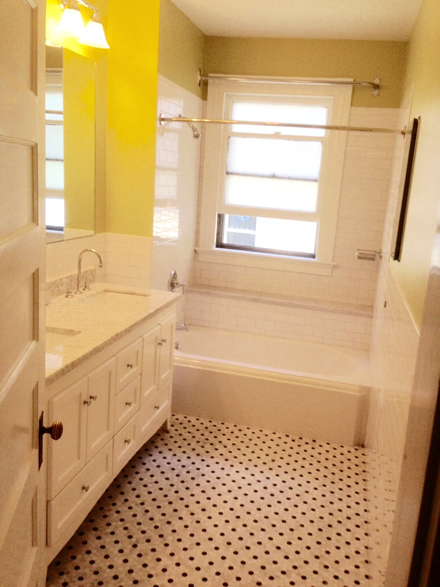 Marble hex floor, kohler memoirs tub, subway tile. windows can be a problem. So we built in a shelf, and put in a curtain.