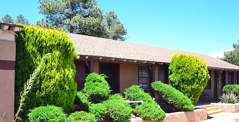 Front view of our rooms nestled behind the evergreens.