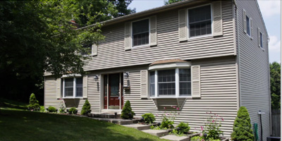 A large, well-maintained Center Hall Colonial with a large yard and pool.