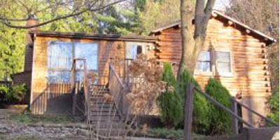 A log-cabin style home on a half-acre, close to all amenities. 