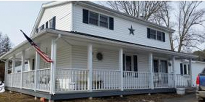 A great country home with sitting porches and large outbuildings.