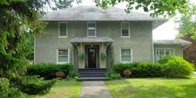 A stately 1920s home full of rich and ornate woodwork and a new gourmet kitchen.