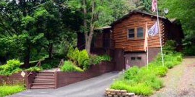 A secluded log home with lush gardens and berry patches.