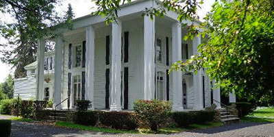 A unique 20-acre estate with 8 apartments, barn, and private residence. 