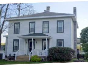 A unique country property with an updated farmhouse, in-law apartment, several acres and a pond.