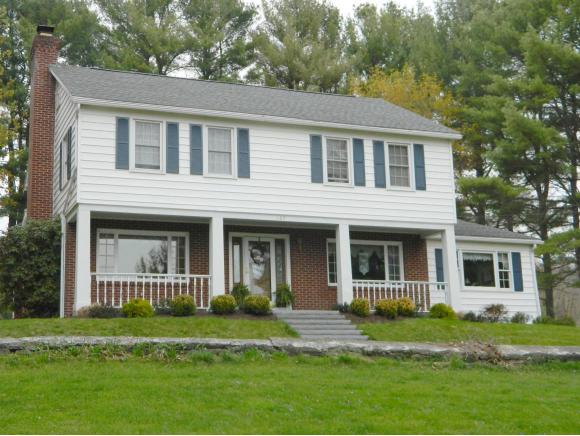 A lovely 2-story on acreage with level lawns.