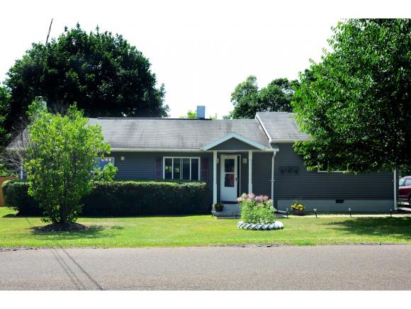 A lovely ranch on an acre of well-developed grounds.
