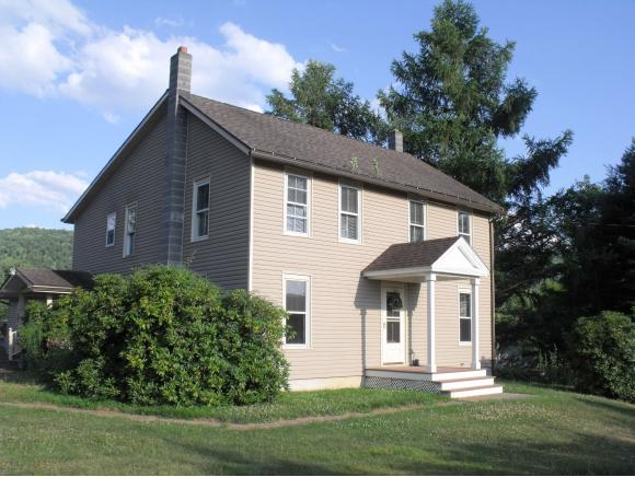 A spacious renovated farmhouse with an in-law apartment and several outbuildings.