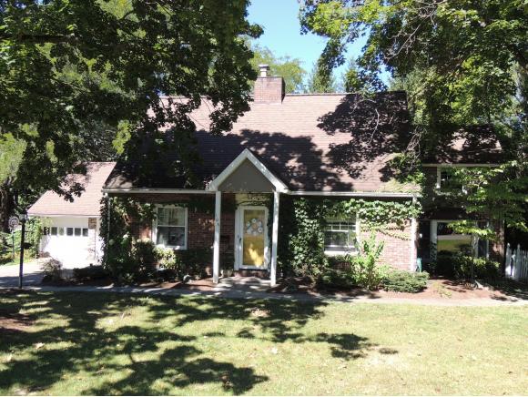 A picturesque cottage-style home with a gourmet kitchen and private yard.