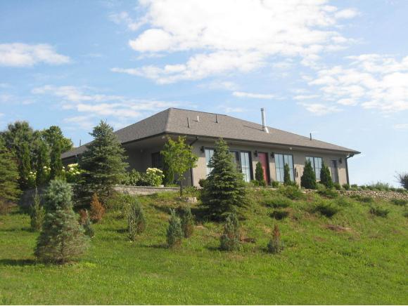A custom-built luxurious home on acres and views for miles.