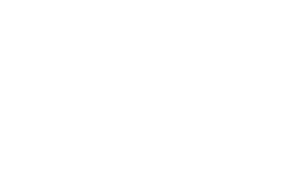 Figures talk around a table.