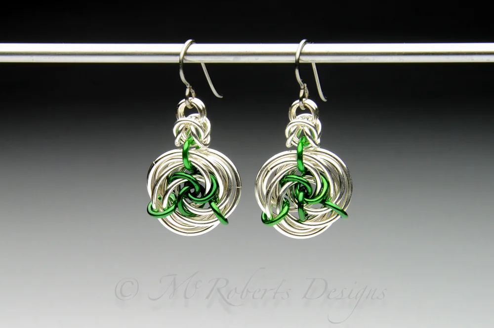These chainmaille earrings are an original design. I call it the Carabell Rose. These are made with tarnish resistant Argentium Silver and Anodized Aluminum rings. The anodized Aluminum is used to add color to the design.