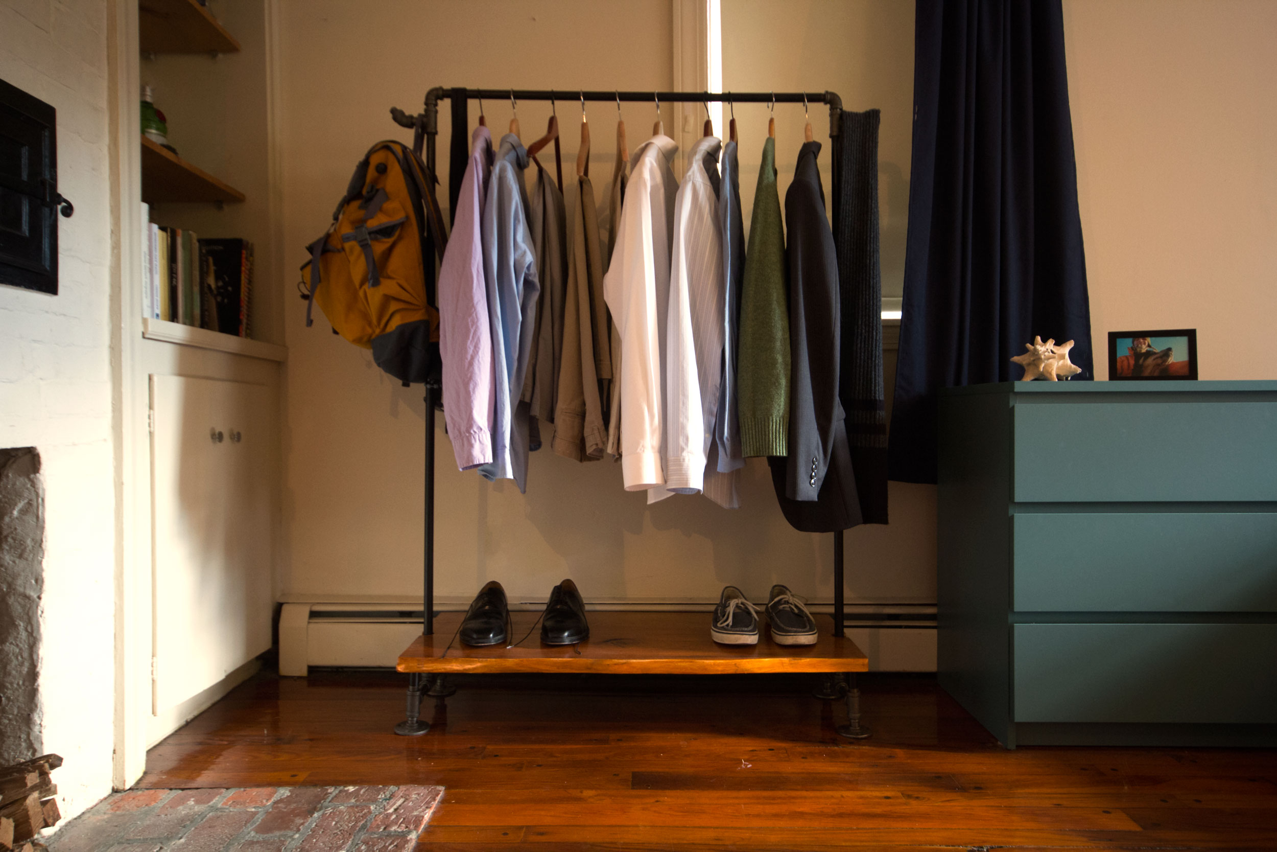 A coat rack constructed with Butternut shelves and 1/2" galvanized steel pipe.