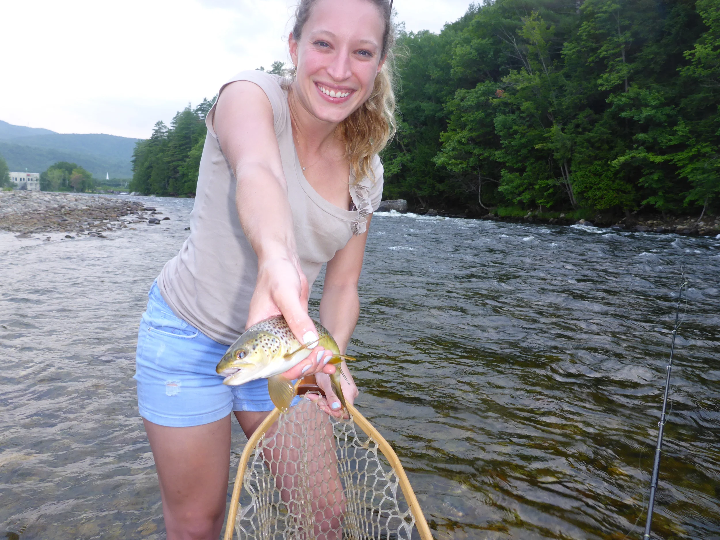 Emily with her first brown trout on the fly!