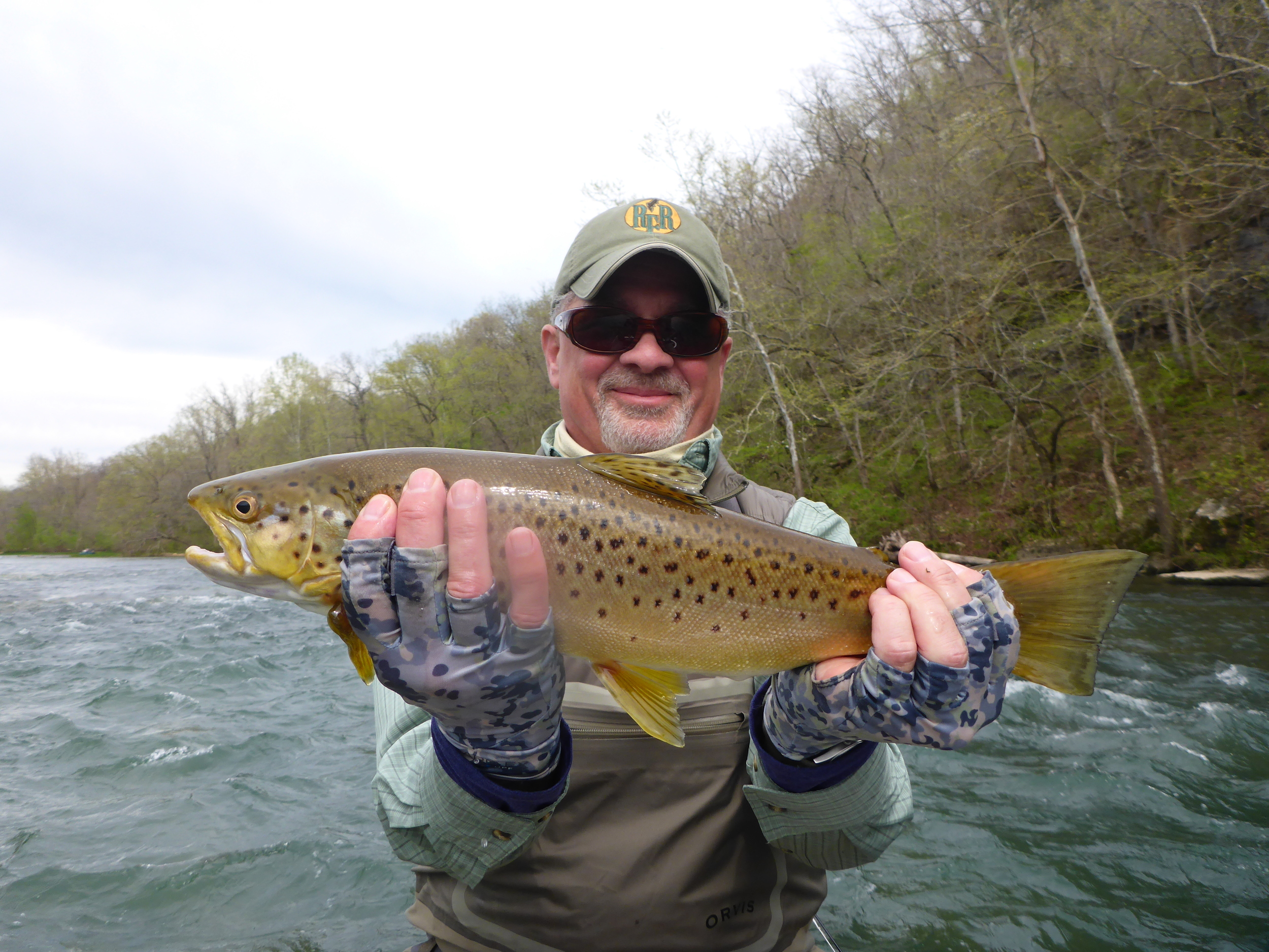 Client Lou with a brown trout from the Norfork River.