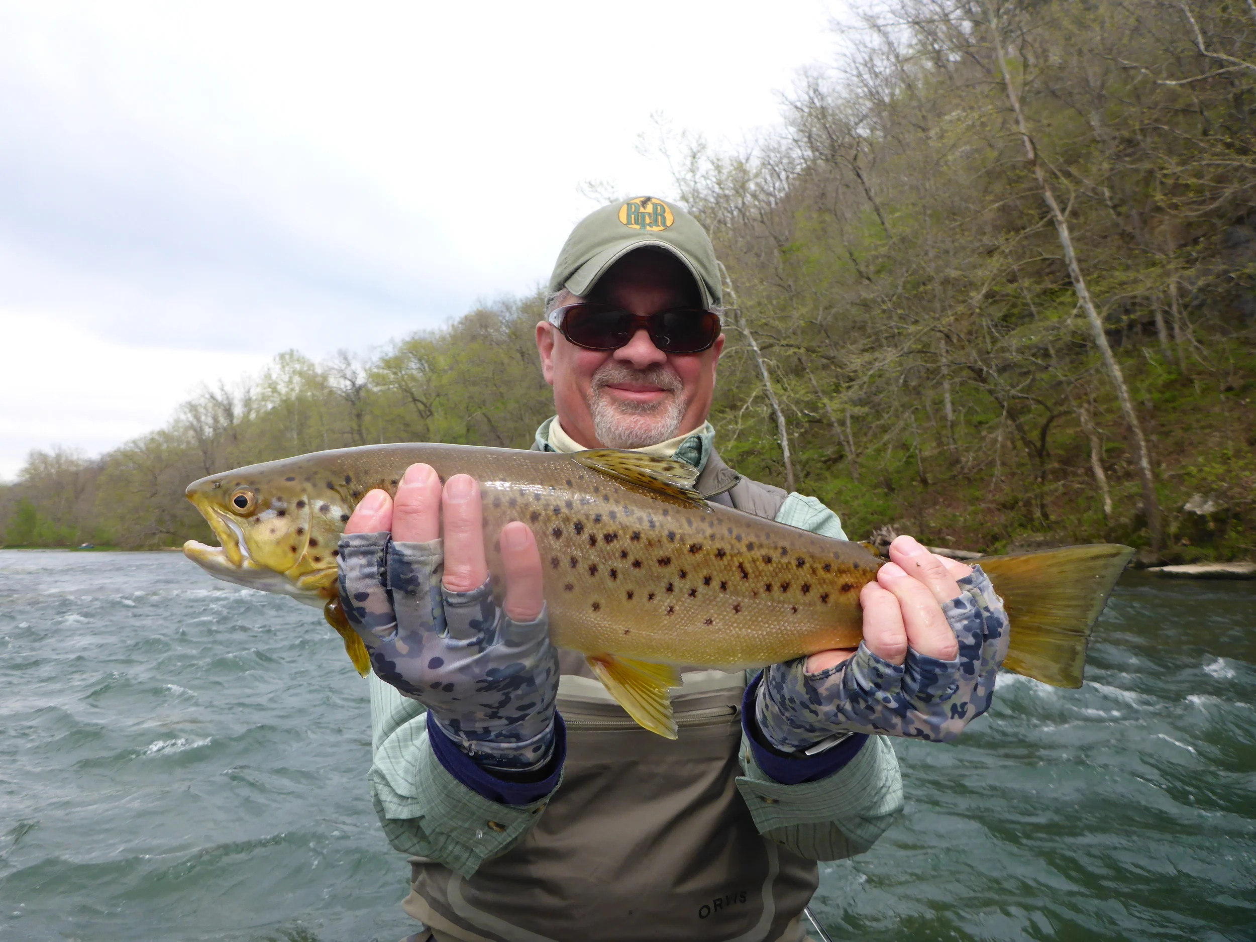 Client Lou with a brown trout from the Norfork River.