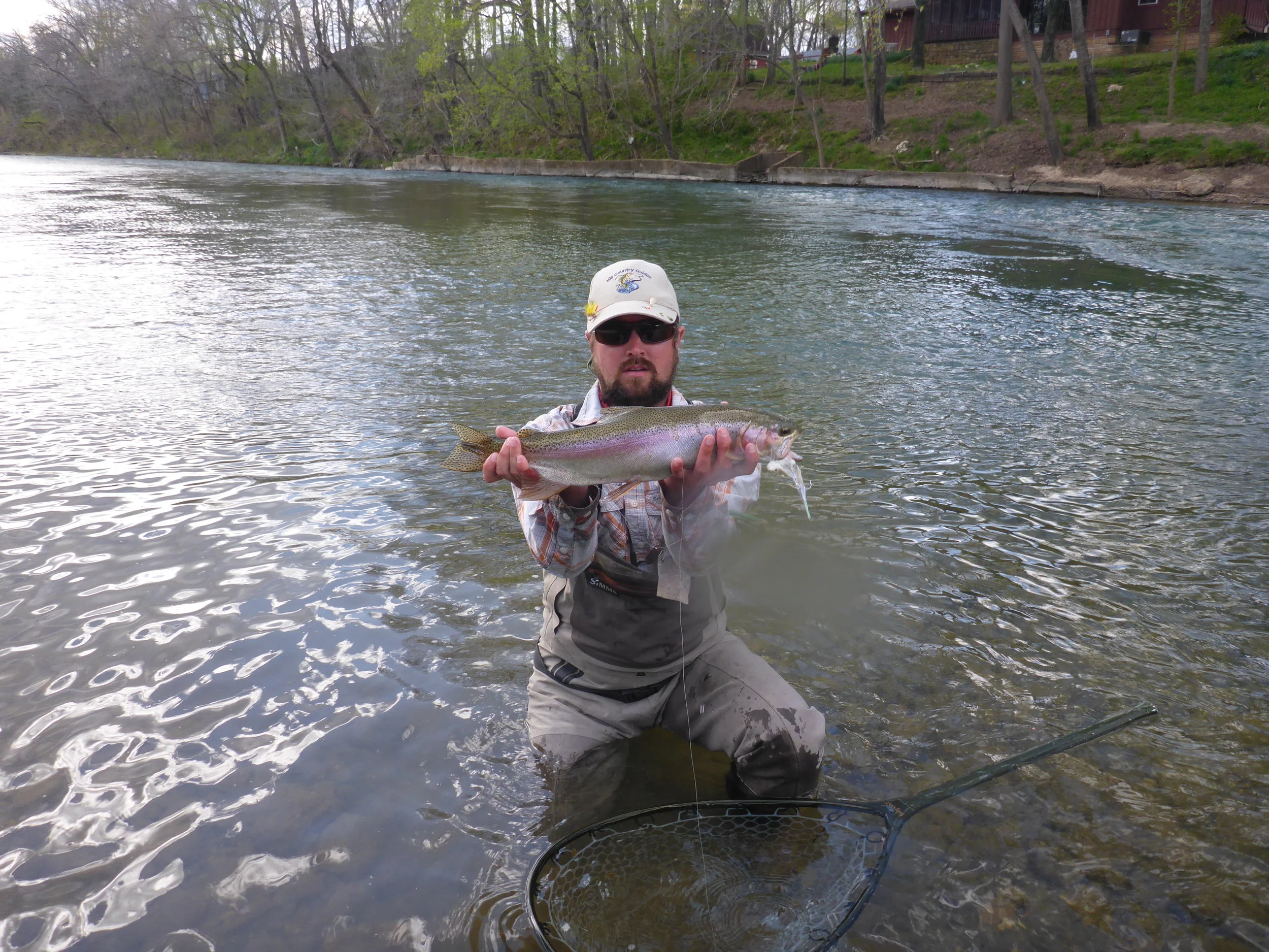 Guide Nate Hill with a trophy wild rainbow trout caught while scouting a stretch of remote water for the first time.