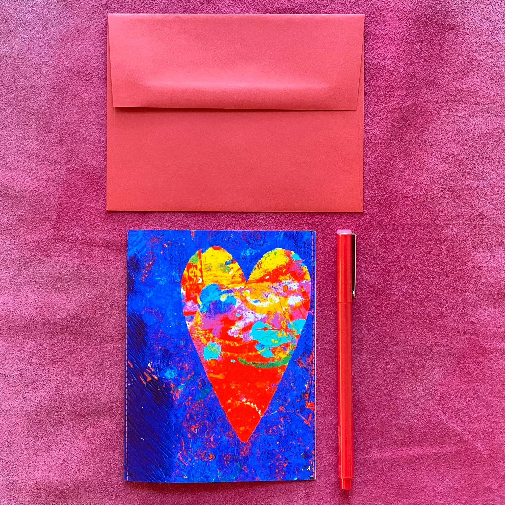 Acrylic heart greeting card with vibrant multicolored heart on deep blue textured background