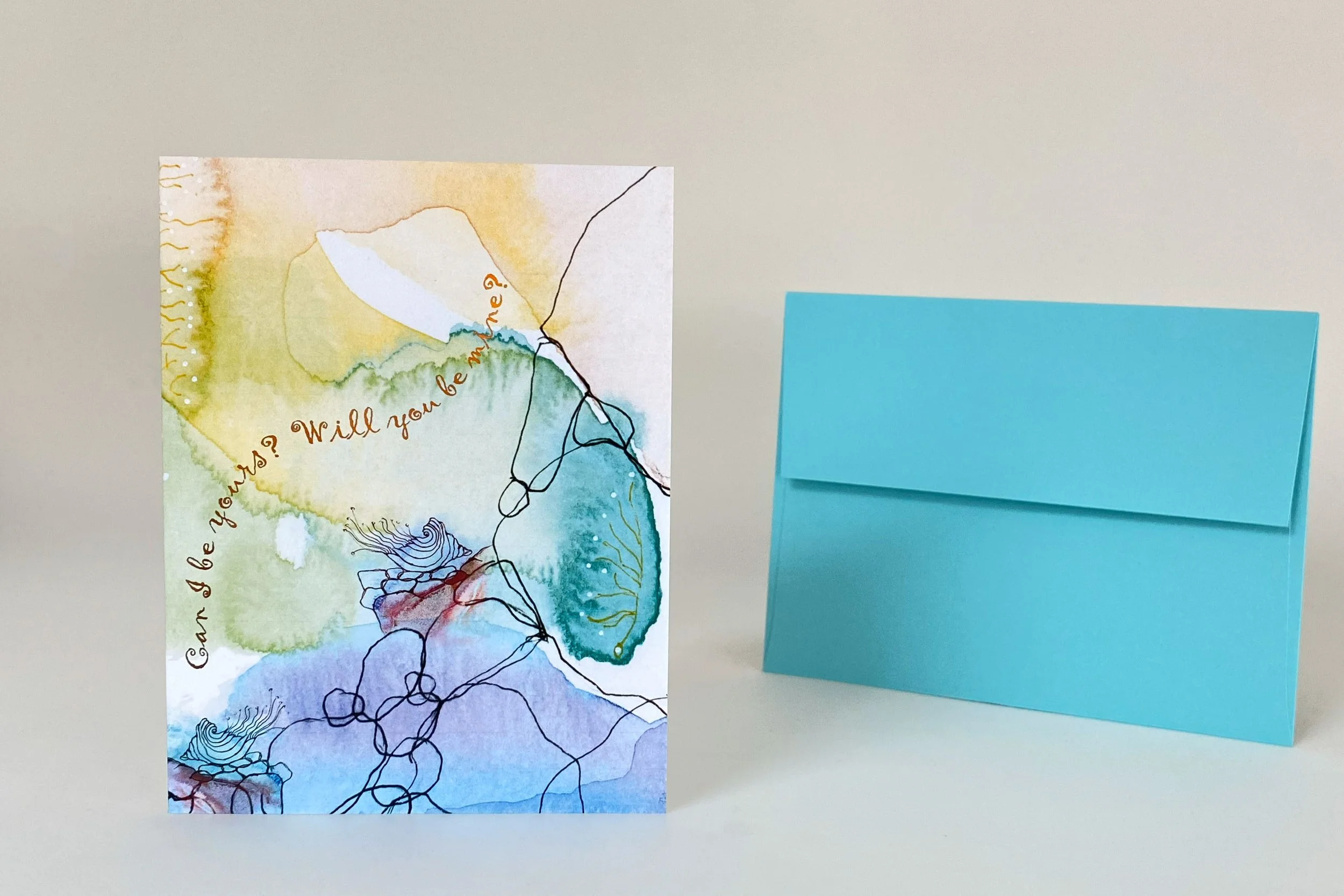 "Can I Be Yours? Will you ne mine?" front message Abstract watercolor greeting card featuring layered blue, green, and earth-tone artwork with expressive line drawing, shown with teal envelope