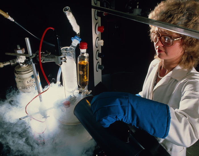 Chemist pouring liquid nitrogen