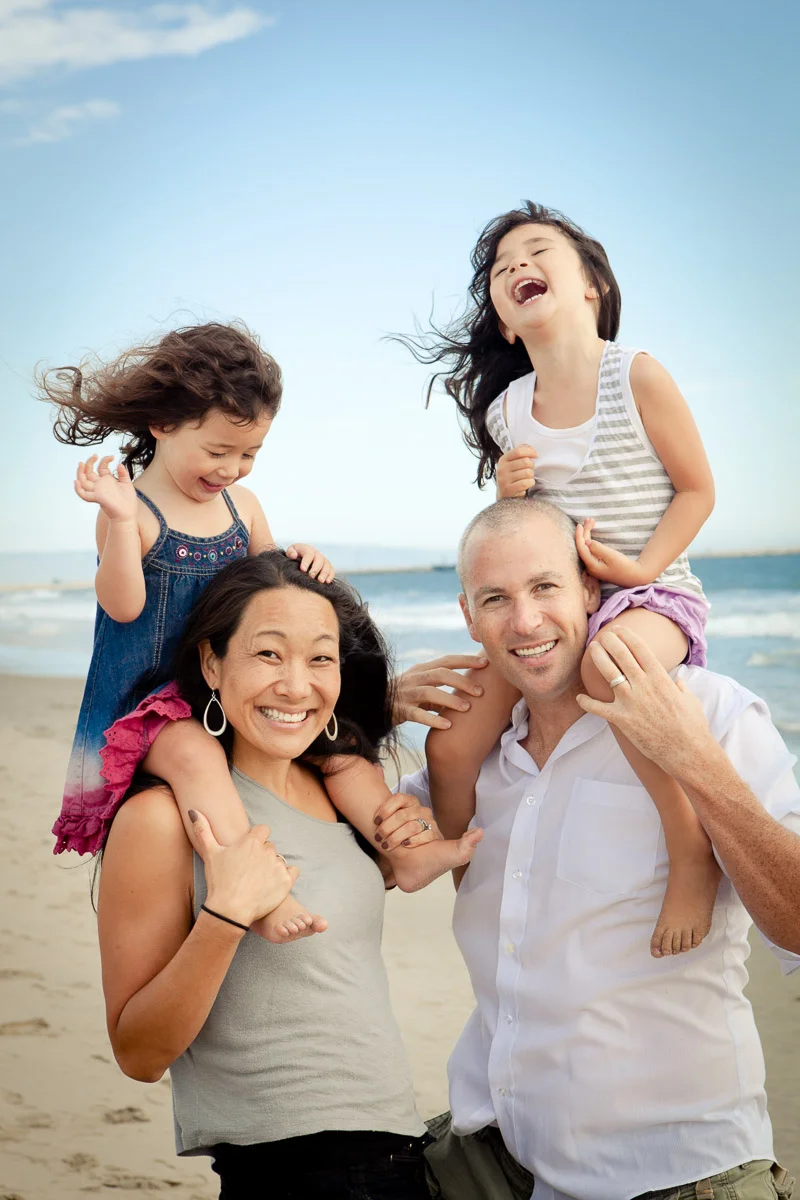 Little girls on parents shoulders