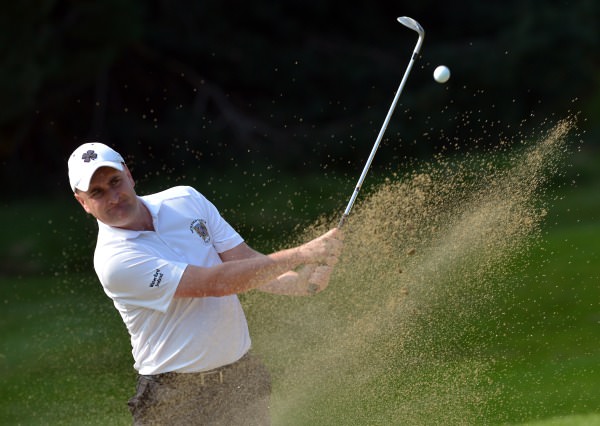 Danny Sinnott (Waterford Castle) plays his bunker shot to the 16th green during the semi final of the I Need Spain Irish Mixed Foursomes at Warrenpoint Golf Club (04/09/2014). Picture by Pat Cashman