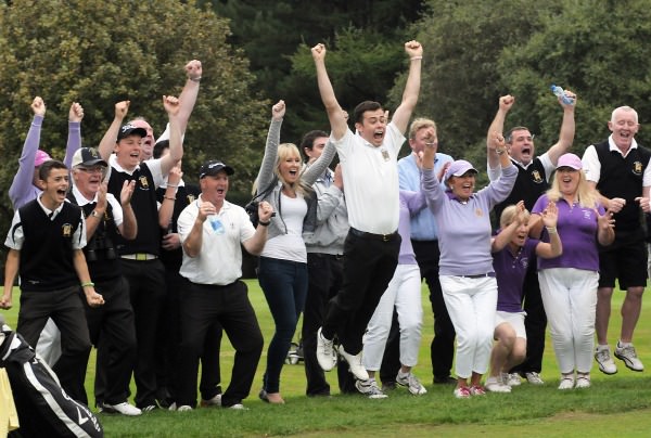Waterford Castle player Sam Power leads the victory dance at the 16th green in the final of the I Need Spain Irish Mixed Foursomes at Warrenpoint Golf Club (05/09/2014). Picture by Pat Cashman