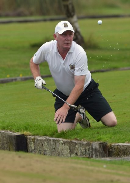 Liam Coady (Waterford Castle) flicks the ball from the water hazard at the 9th green during the final of the I Need Spain Irish Mixed Foursomes at Warrenpoint Golf Club. Picture by Pat Cashman