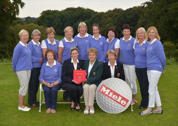 Vonnie Noonan (ILGU Board Member) presenting Julie Connolly (Lady Captain, Cahir Park Golf Club) with the 2014 Miele All Ireland Ladies Interclub Fourball Regional Final pennant after their victory at Athlone Golf Club. Also in the picture in front are Imelda Dilleen (Team Manager) and Lily O'Sullivan (Lady Captain, Athlone Golf Club). At back (from left) Caitlin Fitzgerald, Yvonne Morrison, Chris Noonan, Patricia Brown, Bridget Walsh, Michelle Keating, Phil Barry, Susan Carey ( Joint Team Manager), Breda Keating and Imelda Fitzpatrick. Picture by Pat Cashman