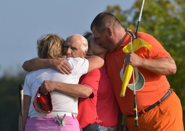 To the Victor a kiss, to the Vanquished a hug........Minna Kaarnalahti (Finland) receives a kiss from her husband caddy JP while caddy Frazer McMullen gives his wife Gertie a hug at the end of the six-hole play off in the 2014 Irish Senior Women's Open Strokeplay at Dundalk Golf Club (12/09/2014). Picture by Pat Cashman
