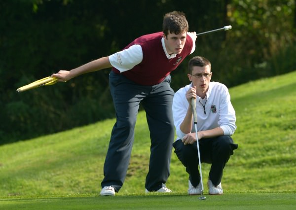 Castletroy's Keith Bermingham with his caddy Ian Irwin lining up his putt in the semi final of the AIG Junior Cup at Carton House today (17/09/2014). Picture by Pat Cashman