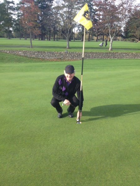 James Donovan picks the ball out of the hole after his second ace of the day, this one on the 19th, at Grange Golf Club