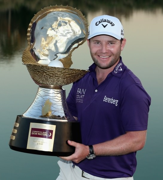 Branden Grace with the Commercial Bank Qatar masters trophy. Picture © Getty Images