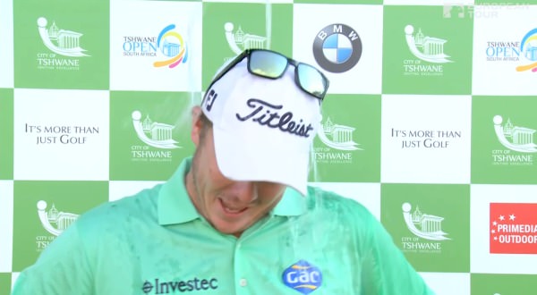 George Coetzee couldn't avoid a soaking from well wishers during his TV interview