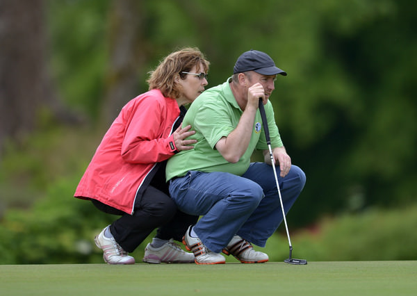 Behind every good man... Joe Lyons (Galway) with his wife Vera lining up his putt on the 18th green during the first day of the 2015 Irish Mid Amateur Open Championship at New Forest Golf Club today (20/06/2015) . Picture by Pat Cashman
