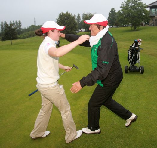 Ulster's Lisa Maguire gets a hug from Senior team Captain Janet Wilson after she had won her match on the 18th to secure the Interprovincial championship title at Wexford golf club yesterday. Picture: Ronan Lang