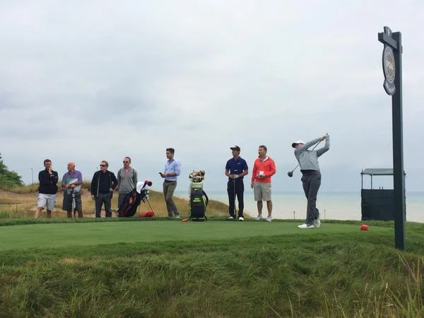 Rory McIlroy, watched by that group that includes his father Gerry, his coach Michael Bannon, his&nbsp;assistant Sean O'Flaherty, his best friend Harry Diamond&nbsp;and his caddie JP Fitzgerald at Whistling Straits today.&nbsp;