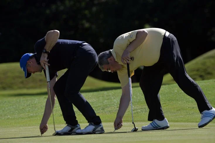 Alan Dowling (Hermitage)and Barry Forsyth (Corballis Links) repairing pitch marks on the 5th green in the final round of the 2015 Leinster Mid Amateur Open Championship at&nbsp;Grange (08/08/2015). Picture by Pat Cashman