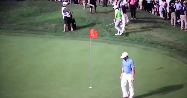 Grill's ball can be seen between the top of the flag and McIlroy