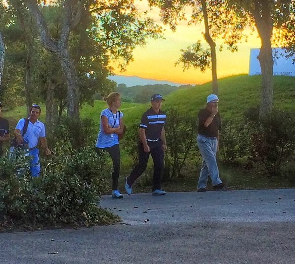 Paul Dunne, accompanied by a representative from his management company (centre left), walks off the 18th at PGA Catalunya Resort's Stadium Course towards the recorders hut following his three under 69 in the fifth round of Q-School, 18 November 2015.