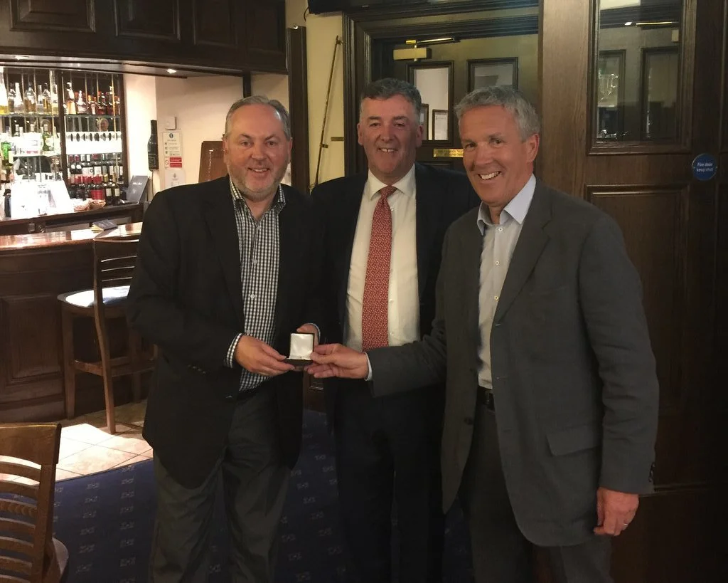 Kevin Knightly, CEO RaboDirect, looks on as Martin Kelly presents Clem Walsh with his gold medal