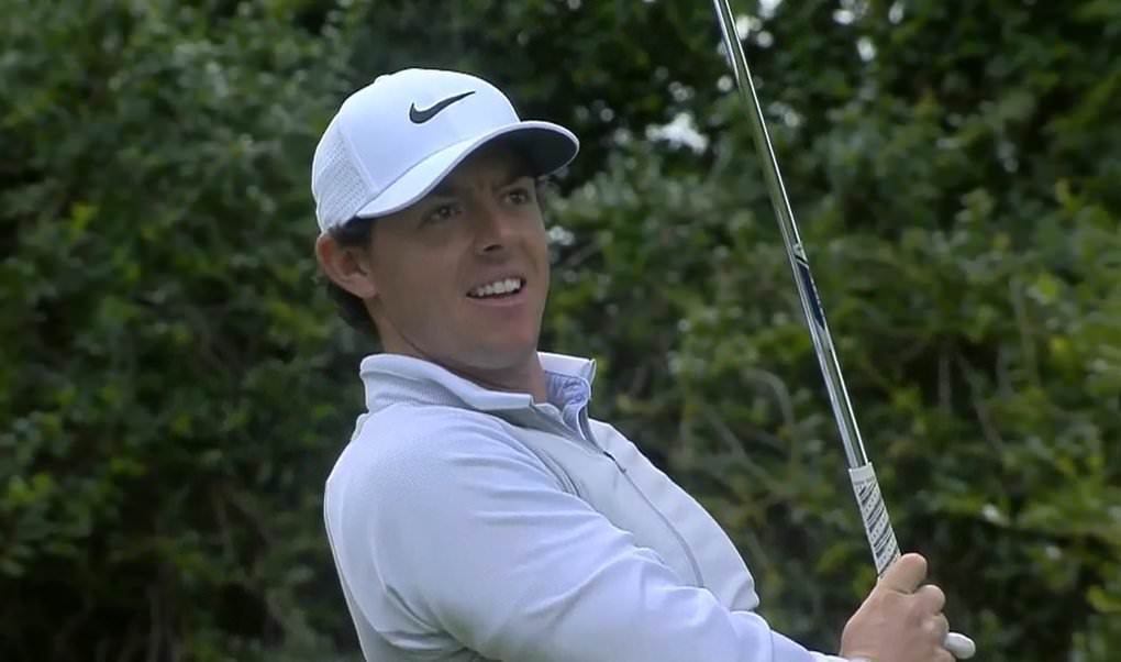 Rory McIlroy watches intently as he almost holes his tee shot at the par-three sixth