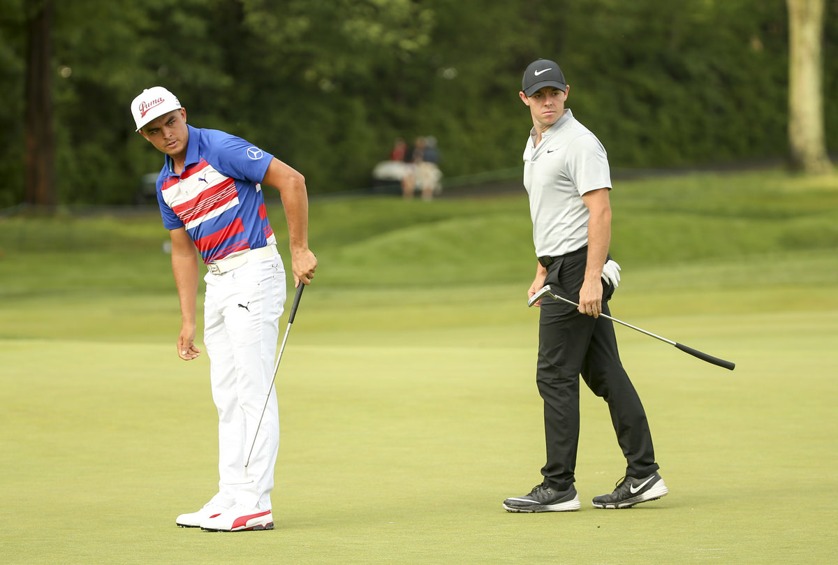 Rory McIlroy, right, watches Rickie Fowler's putt at the second green during the first round for the 2016 U.S. Open. Copyright USGA/Darren Carroll