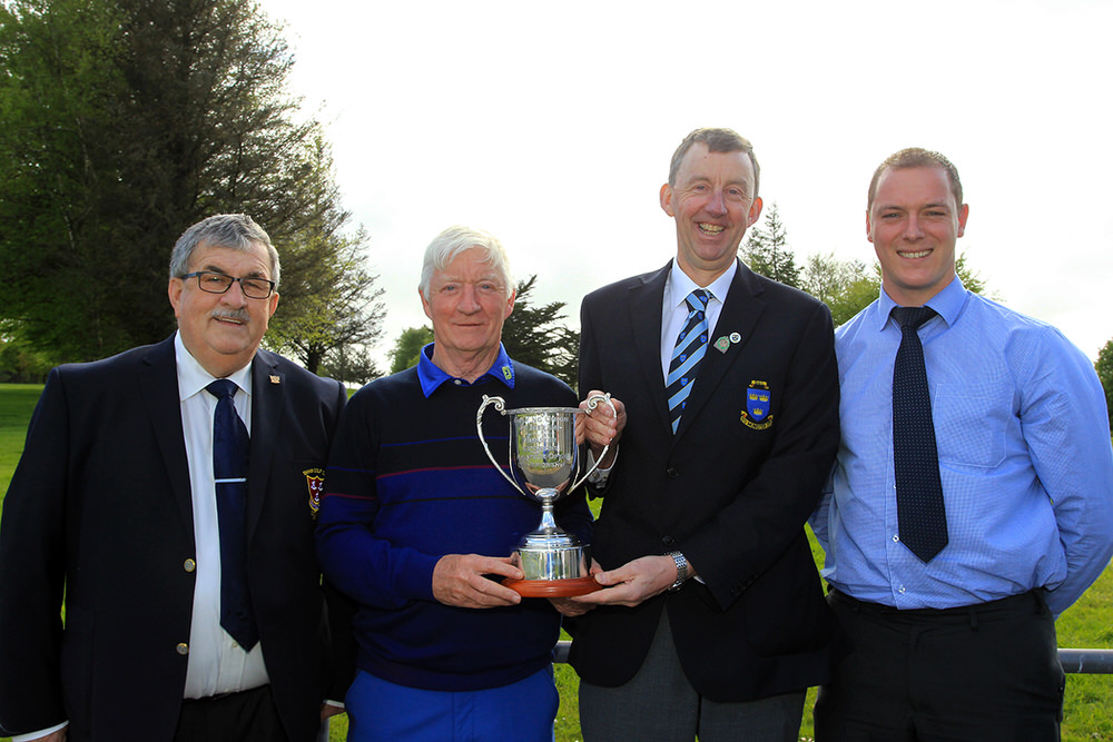 Maurice Kelly (Naas) receiving the Munster Veterans trophy 