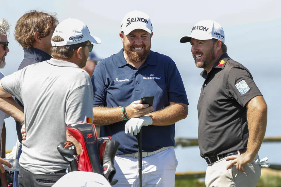 Shane Lowry and Graeme McDowell wait with their caddies on the 18th hole during a practice round at the 2019 U.S. Open at Pebble Beach Golf Links in Pebble Beach, Calif. on Tuesday, June 11, 2019. (Copyright USGA/Michael Reaves)