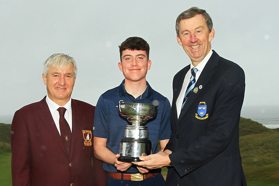  Dylan Keating (Seapoint) accepts the Munster Boys trophy from Jim Long, Chairman Munster Golf.  Also included is Patrick O'Sullivan, Captain Ballybunion Golf Club.Picture: Niall O'Shea 
