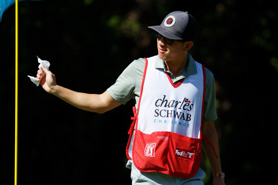  FORT WORTH, TEXAS - JUNE 12: The caddie of Xinjun Zhang of China uses a wipe to hold a pin flag because of COVID-19 during the second round of the Charles Schwab Challenge on June 12, 2020 at Colonial Country Club in Fort Worth, Texas. (Photo by Tom