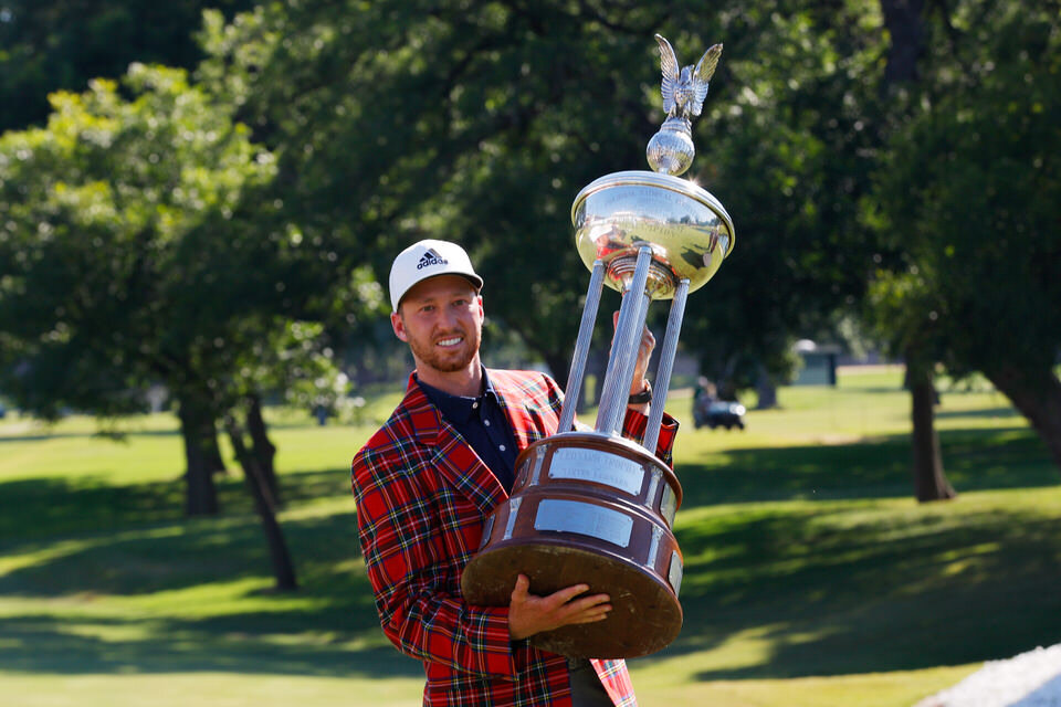  FORT WORTH, TEXAS - JUNE 14: Daniel Berger of the United States celebrates with the plaid jacket and Leonard Trophy after defeating Collin Morikawa of the United States in a playoff during the final round of the Charles Schwab Challenge on June 14, 